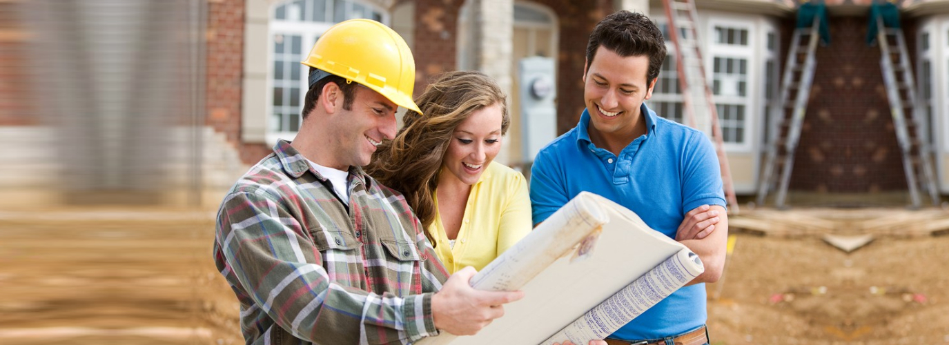 Construction: Young Couple Look At Home Plans with Builder